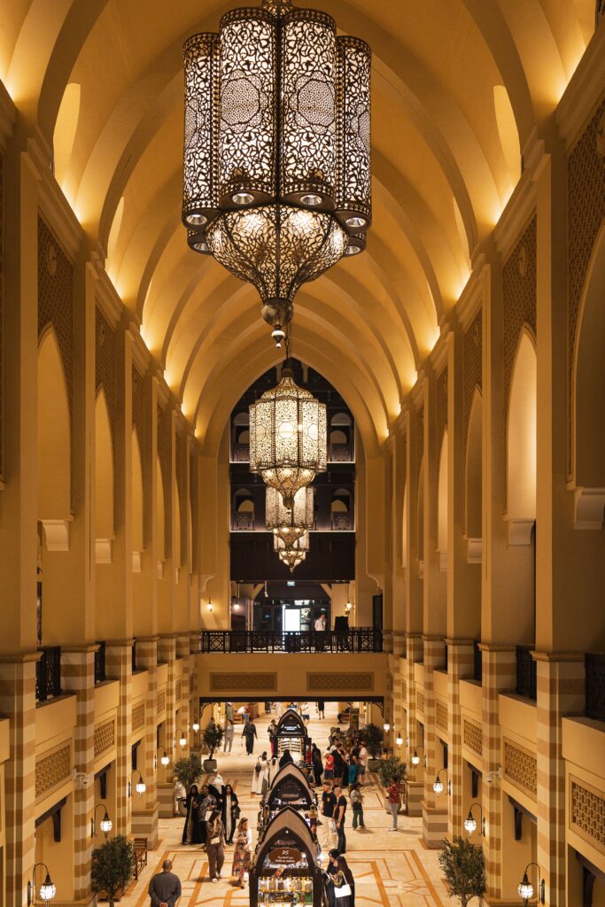 Stunning interior view of Dubai Mall showcasing an ornate chandelier over a bustling shopping area.