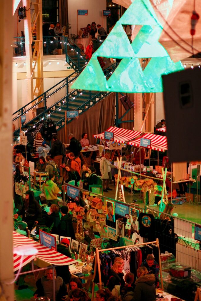 Vibrant Christmas market scene in Bratislava with decorations and shoppers enjoying holiday festivities.