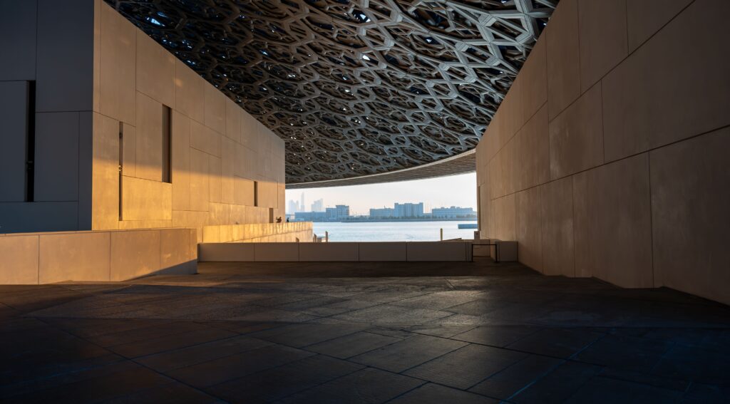 Explore the geometric design of Louvre Abu Dhabi during golden hour.